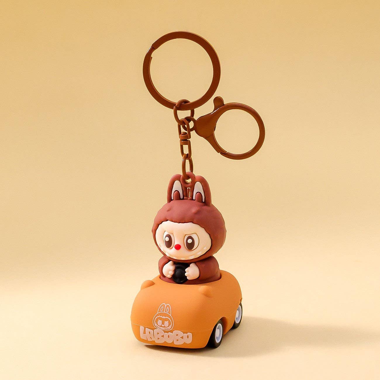 Labubu driving cartoon keychain Labubu pendant gift: Driving-Brown